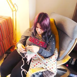 Estelle sat in a rocking chair knitting